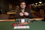 Tomer Berda proudly displays his newly won bracelet after shipping event #56