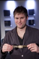 Simon Watt poses for a picture with his bracelet. 