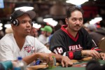 Phil Ivey and Steve Wong look up to hear what the dealer has to say. (That or a pretty girl walked by)