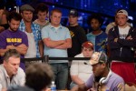 Event 52 rail-birds stand behind Vadim Trincher and Martins Adeniya.  