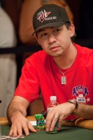 Kenny Tran stacks and shuffles his chips.