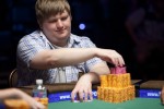 Peter Gelencser reaches for chips at the final table of Event #7.