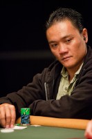 Ut Nguyen peeks at his cards stares down