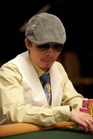 Hoai Pham, the winner of event 1, watches play at the final table.