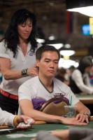 John Juanda gets his neck rubbed while he prepares for a long day of poker.  